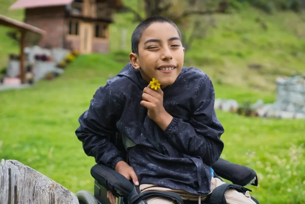 Happy disabled man in wheelchair smiling at camera